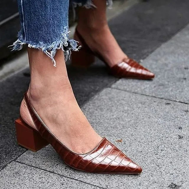 Croc-embossed pointed toe slingback pumps worn side view