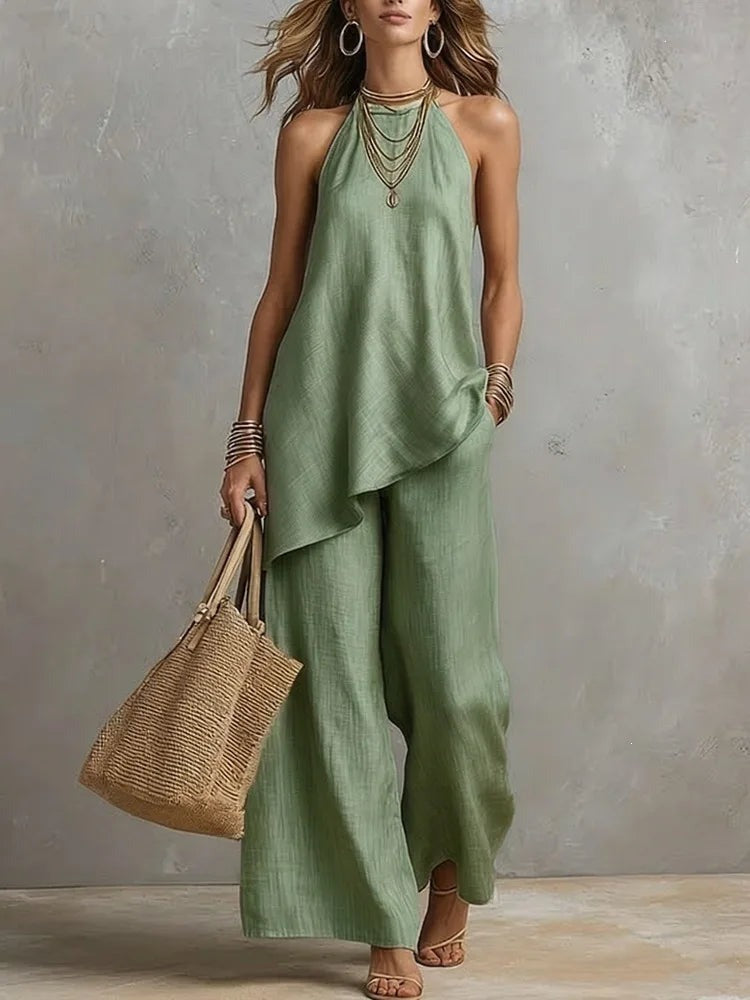 Sleeveless halter top with draped hem and wide leg pants front view
