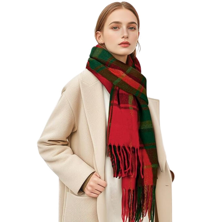 Plaid winter scarf with tassel fringe worn over a coat front view